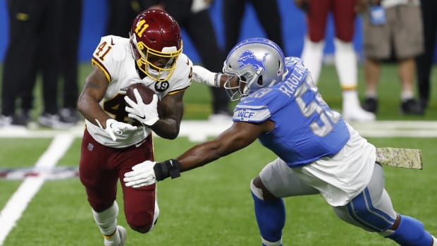 Nov 15, 2020; Detroit, Michigan, USA; Washington Football Team running back J.D. McKissic (41) runs the ball against Detroit Lions inside linebacker Reggie Ragland (59) during the first quarter at Ford Field.